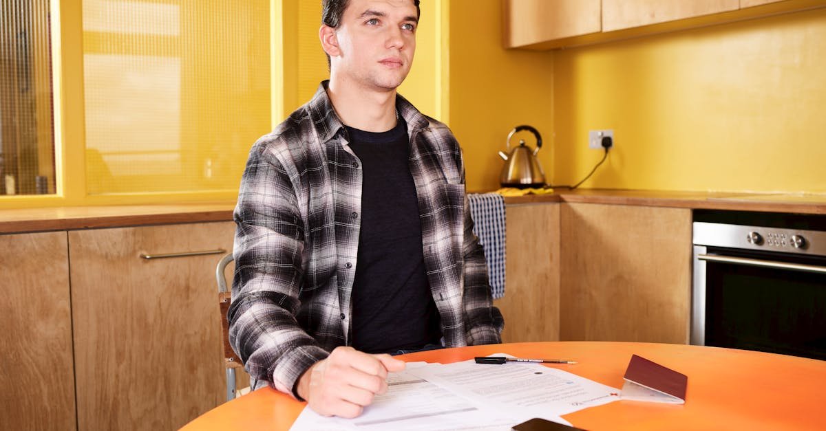 A person learning how to read an explanation of benefits statement at a kitchen table