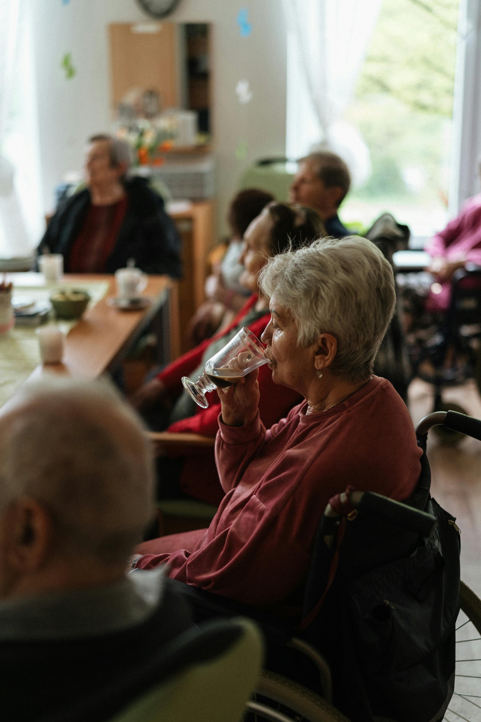 An older couple reviewing paperwork and comparing assisted living communities at a kitchen table