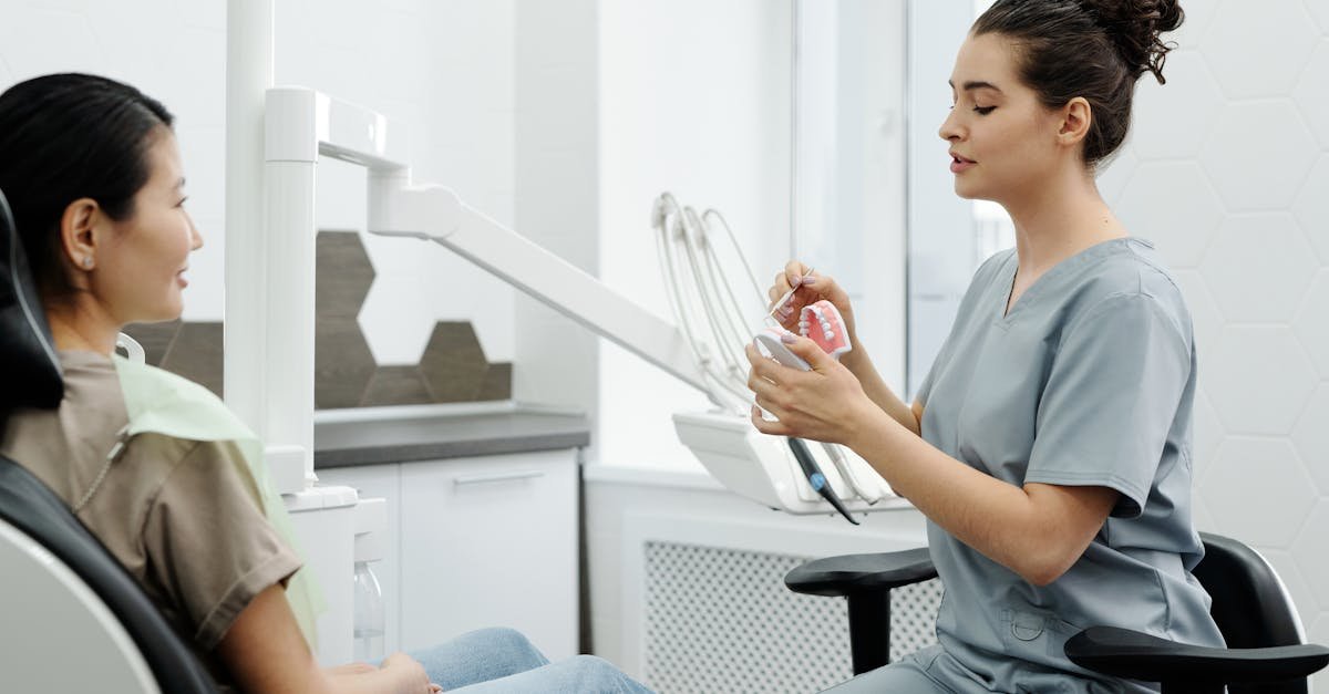 A dentist explaining dental implants cost to a patient in a clean modern operatory