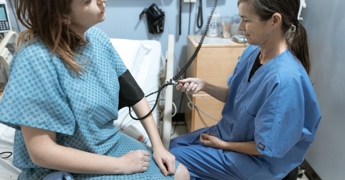 A person having their blood pressure checked while managing high blood pressure