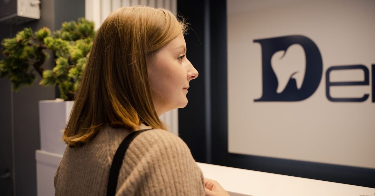 A patient reviewing a dental implants cost estimate with the front desk