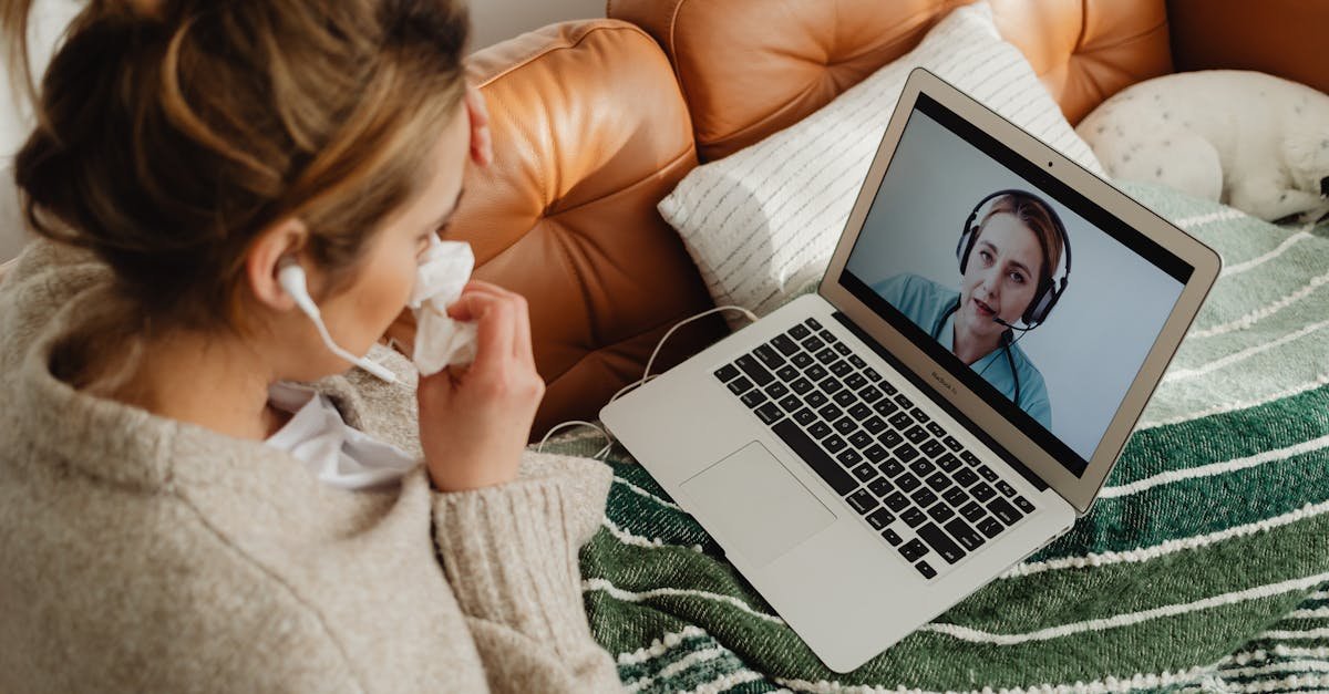 A patient on a video call with a clinician using telehealth that takes insurance at home