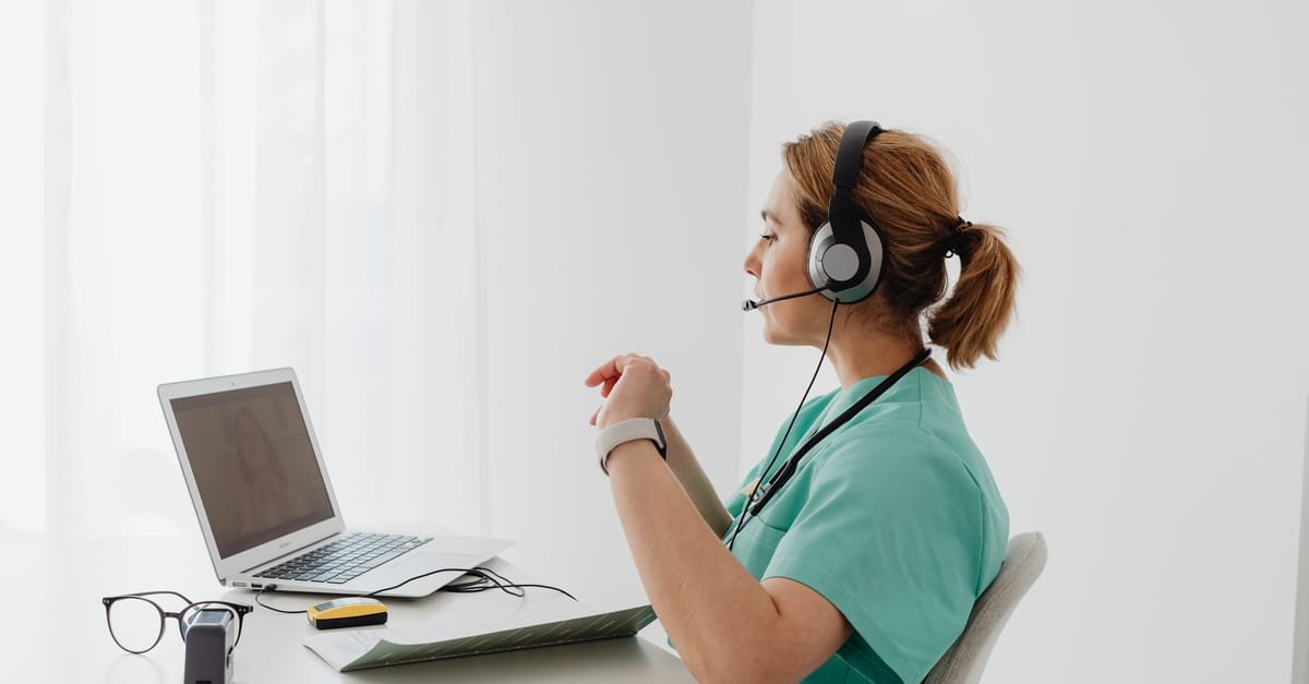 A clinician wearing a headset during a telehealth that takes insurance video visit