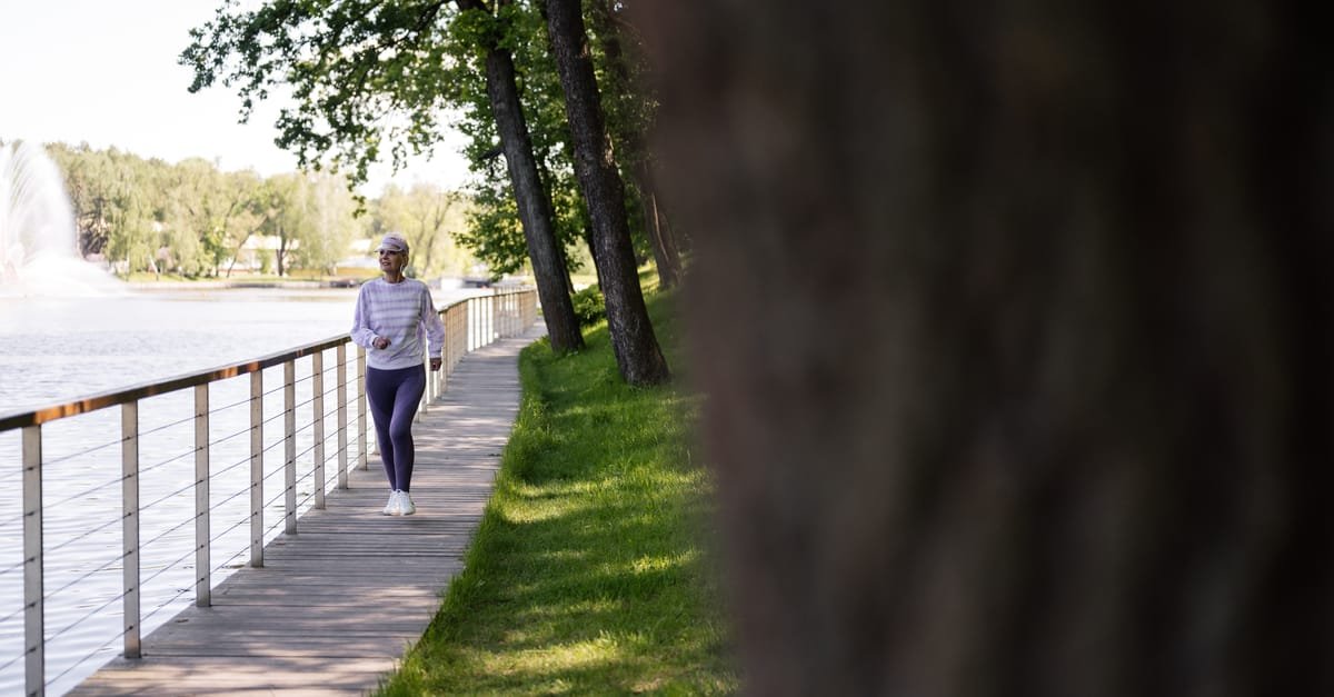 A person walking outdoors as part of managing high blood pressure through activity