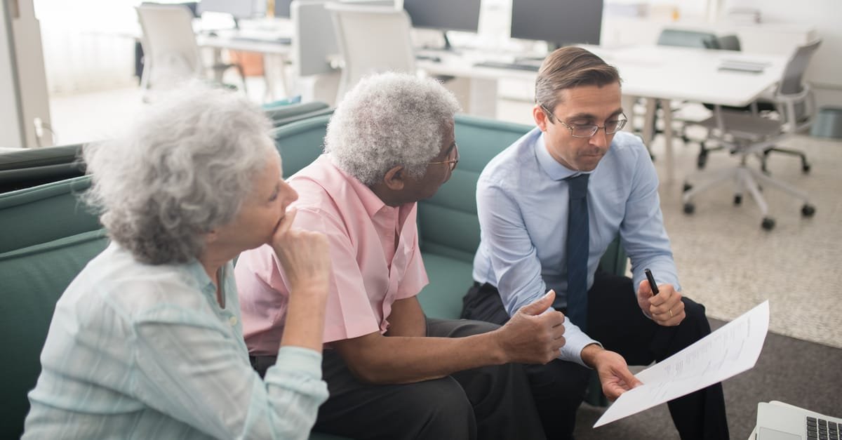 A senior reviewing Medicare Advantage vs Medigap plan documents with a licensed agent